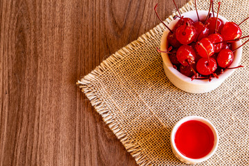 Delicious cherries in bowl on wooden background