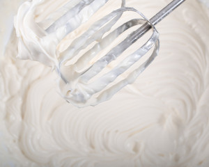 Whipped cream and mixer preparing dessert view from above