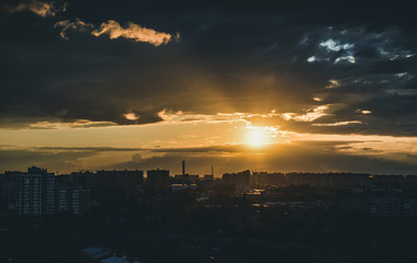 city in the rays of the setting sun