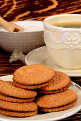 Fototapeta na wymiar cookies next to a retro-style mug full of black coffee