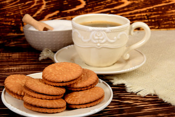 cookies next to a retro-style mug full of black coffee