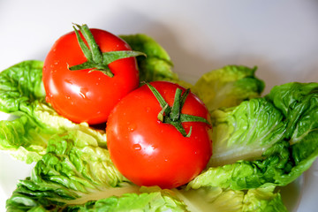 Fresh red tomatoes on lettuce leaves