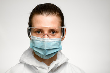 young woman in medical mask and goggles for protection against influenza.