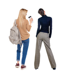 Back view of two woman in sweater.