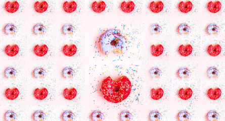 Colored donuts with colorful sprinkles on pink background. National Donut or Doughnut day concept. Pattern