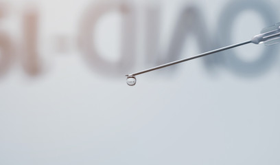 COVID-19 word reflected inside vaccine drop. Vaccine injection dripping with copy space