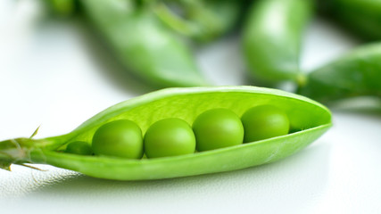 New harvest of fresh ripe green peas. legumes.Green peas and pea pods on white background.Close-up