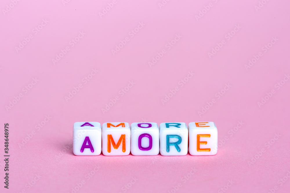 Fototapete the word love in italian. beads in the form of a cube with text on a pink background. concept design