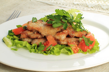close up of potato with chicken with vegetables and salad on plate