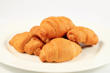 Naklejka premium close up of croissants on plate on white background