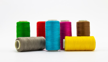 Group of whole haberdashery item colorful thread spools isolated on white background. Coloured threads. Colorful bobbin thread. 