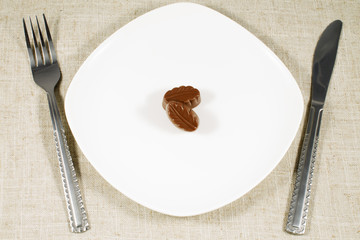 close up of chocolate candies on white plate