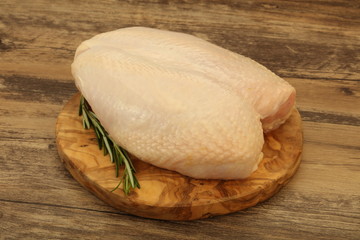 Raw whole chicken breast with skin