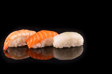 Simple sushi nigiri maki set isolated on black background. Various selection of traditional japanese