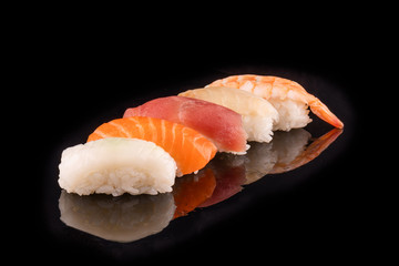 Simple sushi nigiri maki set isolated on black background. Various selection of traditional japanese
