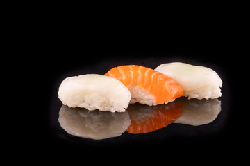 Simple sushi nigiri maki set isolated on black background. Various selection of traditional japanese