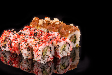 Simple sushi nigiri maki set isolated on black background. Various selection of traditional japanese