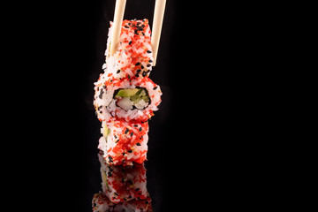 Simple sushi nigiri maki set isolated on black background. Various selection of traditional japanese