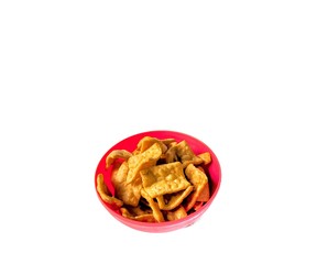 Bowl with pork rind on white background. junk food concept