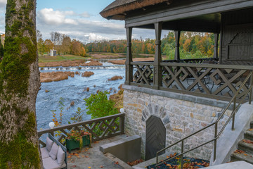 View of the Rumba waterfall in Kuldiga in the fall. Colorful leaves. Beautiful landscape in Latvia.
