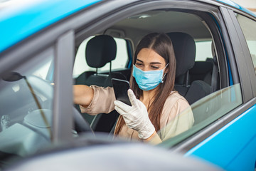 Driving car with face mask. Young woman driving car with protective mask on her face. Healthcare, virus protection, allergy protection concept. Driving car with face mask