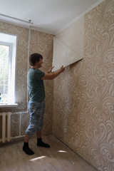 renovation in a new apartment by new residents, tear the Wallpaper off the wall