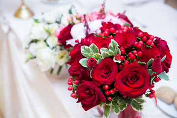Wedding bride bouquet red roses on a white table