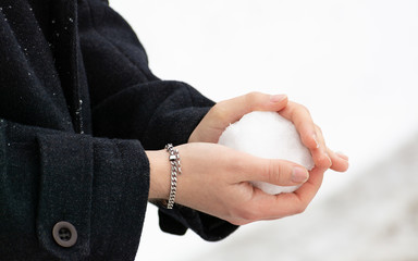 hands of a man making a snowball