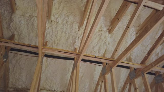 New home construction with installation of termal insulation installing at the attic the roof