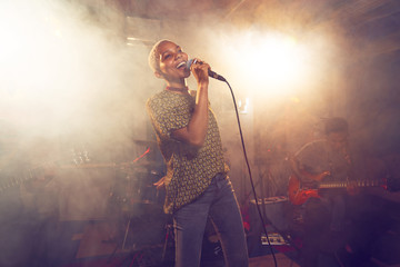 Young female singer performing on stage