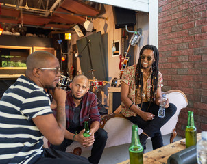 Male musician friends hanging out and drinking beer