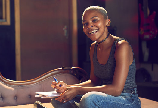 Portrait confident female musician song writing