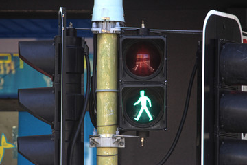 Suburban traffic lights with pedestrian lights showing green for walk. 