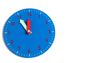 Blue wooden clock on a white background. Closeup. Copy space for text.