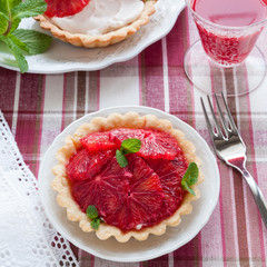 Blood Orange Tartlets. Homemade Pie Crust Filled with Whipped Cream and Fresh Citrus