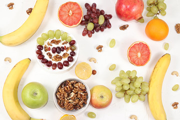 Healthy breakfast, food for children, yogurt with granola, oranges, bananas and grapes on a light table. The concept of a healthy and natural diet, lifestyle. selective focus