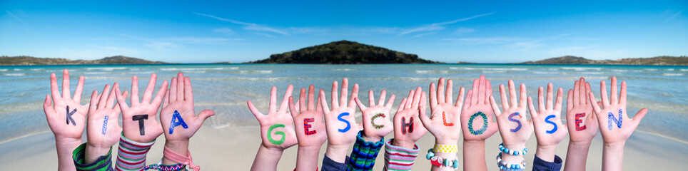 Children Hands Building Colorful German Word KITA geschlossen Means Kindergarden Closed. Ocean And Beach As Background - obrazy, fototapety, plakaty
