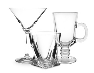 Set of empty glasses on white background