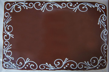 The edges are decorated with white cream . Dark chocolate cake.