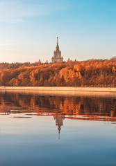 Fototapeta na wymiar Reflection of MSU. Moscow State University. Autumn Park. Vorobyovy Gory and Luzhnetskaya embankment.