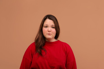 A sad expression of the young girl's face. Bright red jacket.