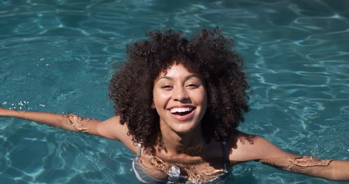 Mixed race woman enjoying her time in a pool