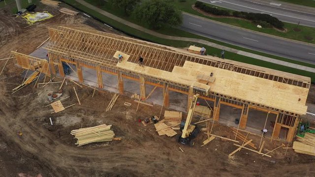 Installing Plywood Roof Sheathing on an Automotive Service Building, Bryan, Texas, USA