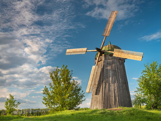 view to old wooden wind mill in Ukraine uner blue sky with copy space