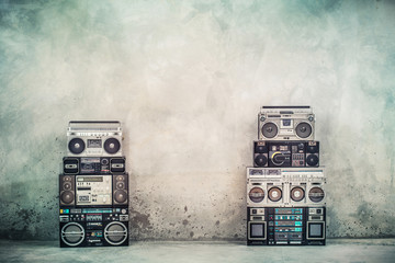 Retro old design ghetto blaster boombox radio cassette tape recorders from 1980s front concrete street wall. Nostalgic Rap, Hip Hop, R&B music concept. Vintage style filtered photo - obrazy, fototapety, plakaty