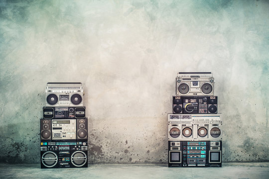 Retro old design ghetto blaster boombox radio cassette tape recorders from 1980s front concrete street wall. Nostalgic Rap, Hip Hop, R&B music concept. Vintage style filtered photo