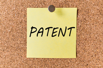 PATENT - word written on a sticker sheet of paper or notes on corkwood (cork tree) panel board. Business concept.