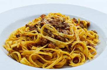 Fettuccine with bolognese ragu and parmesan. Italian pasta. Close-up. 