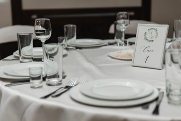 wedding decor in the banquet hall,wedding table decorated with wedding decorations,honeymoon table,arrangement of holiday dishes on the table,seating at the wedding table