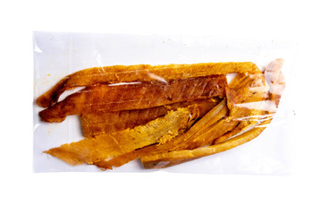 Peruvian squid in a transparent package isolated on white background. Snack on fish with beer....